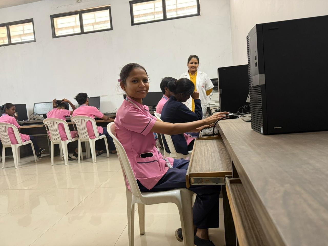 Students at workstations with faculty supervising